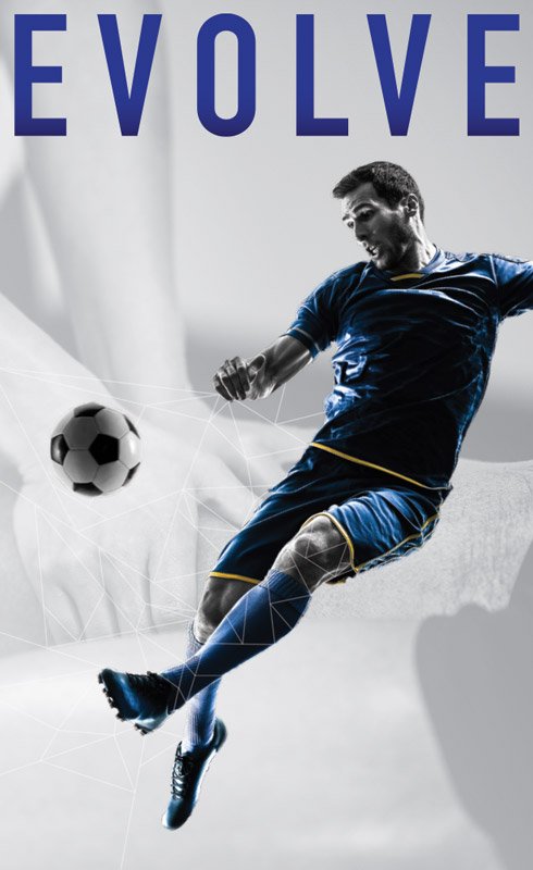 Man in blue jersey kicking a soccer ball